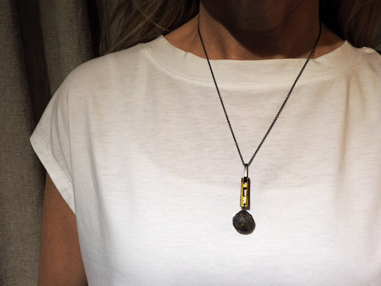 Unique handcrafted fine silver crochet ball hand stitched around a 22kt gold leafed sterling silver ball. Adding a simple modern Rectangle piece in sterling silver with 22kt gold leaf, and a wide sterling silver rectangle bail, hanging on an oxidized sterling silver rollo chain , By ZEALmetal, Nicole Horlor, in Kingston, ON, Canada