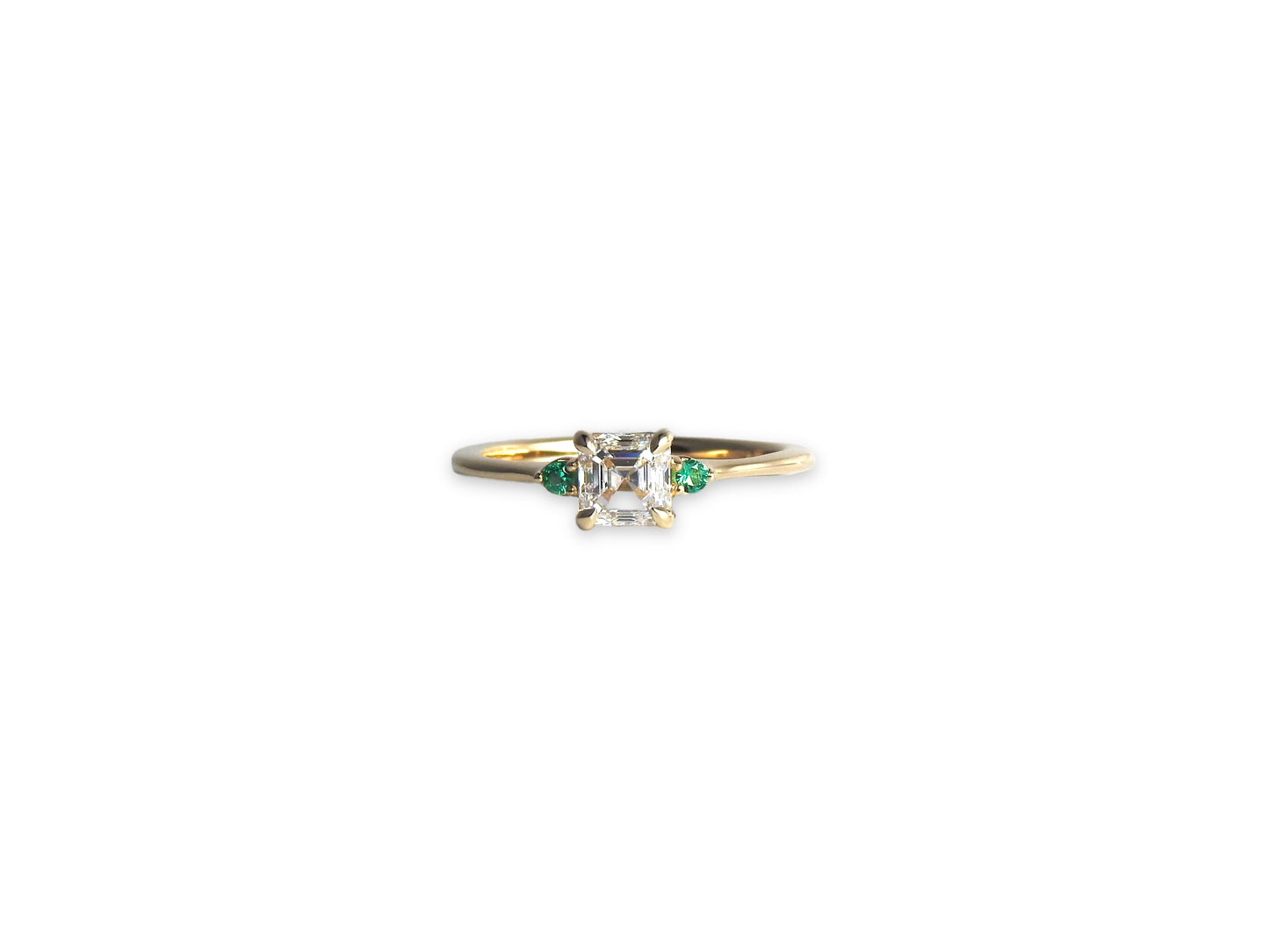 Bespoke engagement ring with an asscher cut diamond and accent emeralds in 14kt yellow gold, by ZEALmetal, Nicole Horlor, in Kingston, ON, Canada