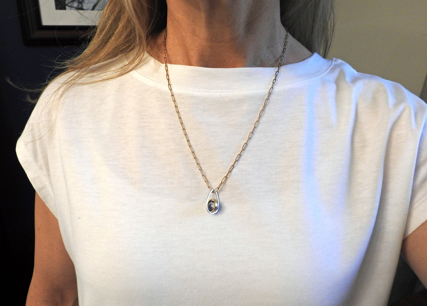 Worldly perspective: new pendant added to the Astral collection . 14 kt yellow gold band within sterling silver wire drop shape holding a free floating worldly looking sodalite undrilled sphere bead. on 14kty 18" cable chain, by ZEALmetal, Nicole Horlor, in Kingston, ON, Canada