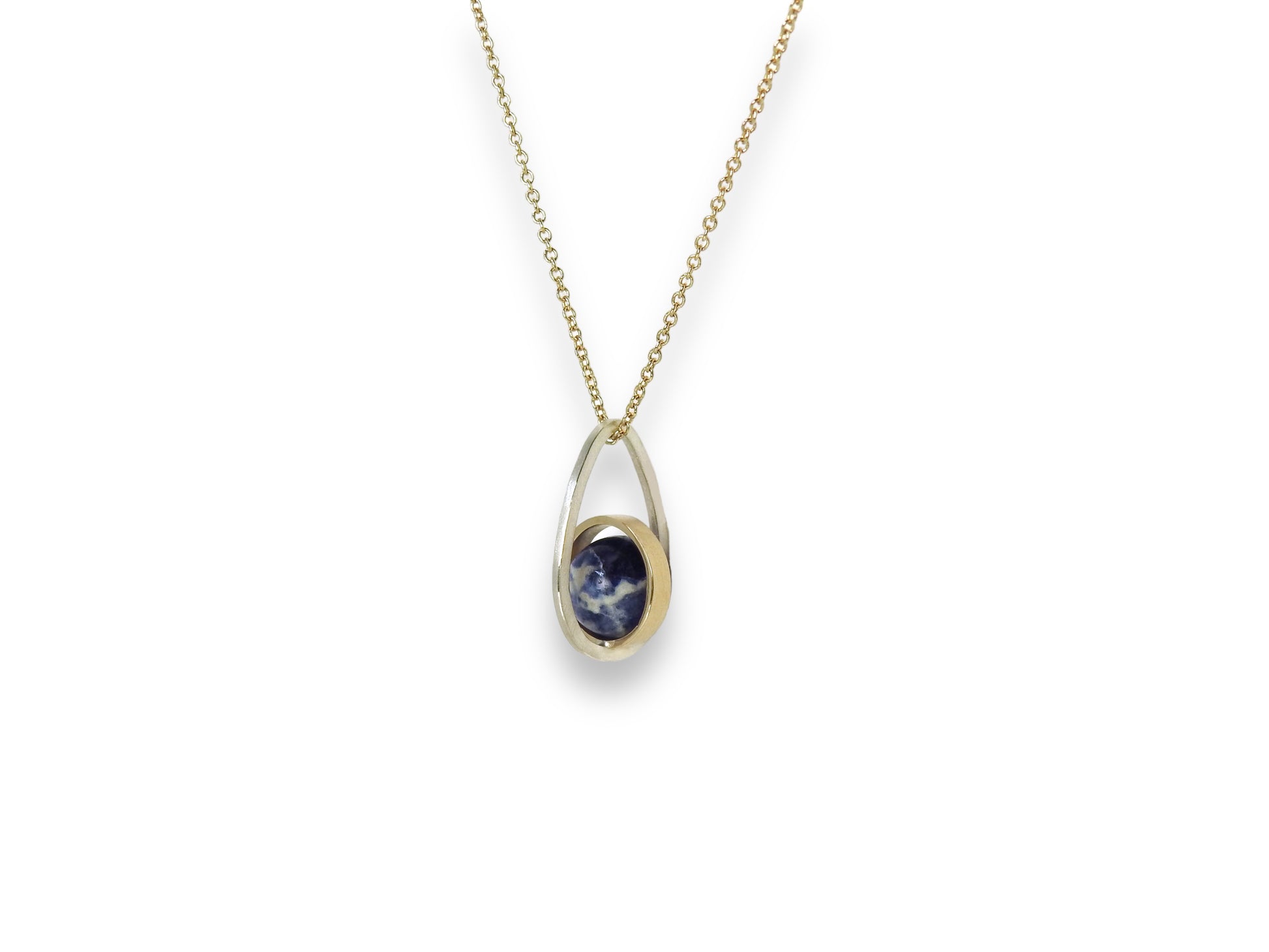 Worldly perspective: new pendant added to the Astral collection . 14 kt yellow gold band within sterling silver wire drop shape holding a free floating worldly looking sodalite undrilled sphere bead.   on 14kty 18" cable chain, by ZEALmetal, Nicole Horlor, in Kingston, ON, Canada