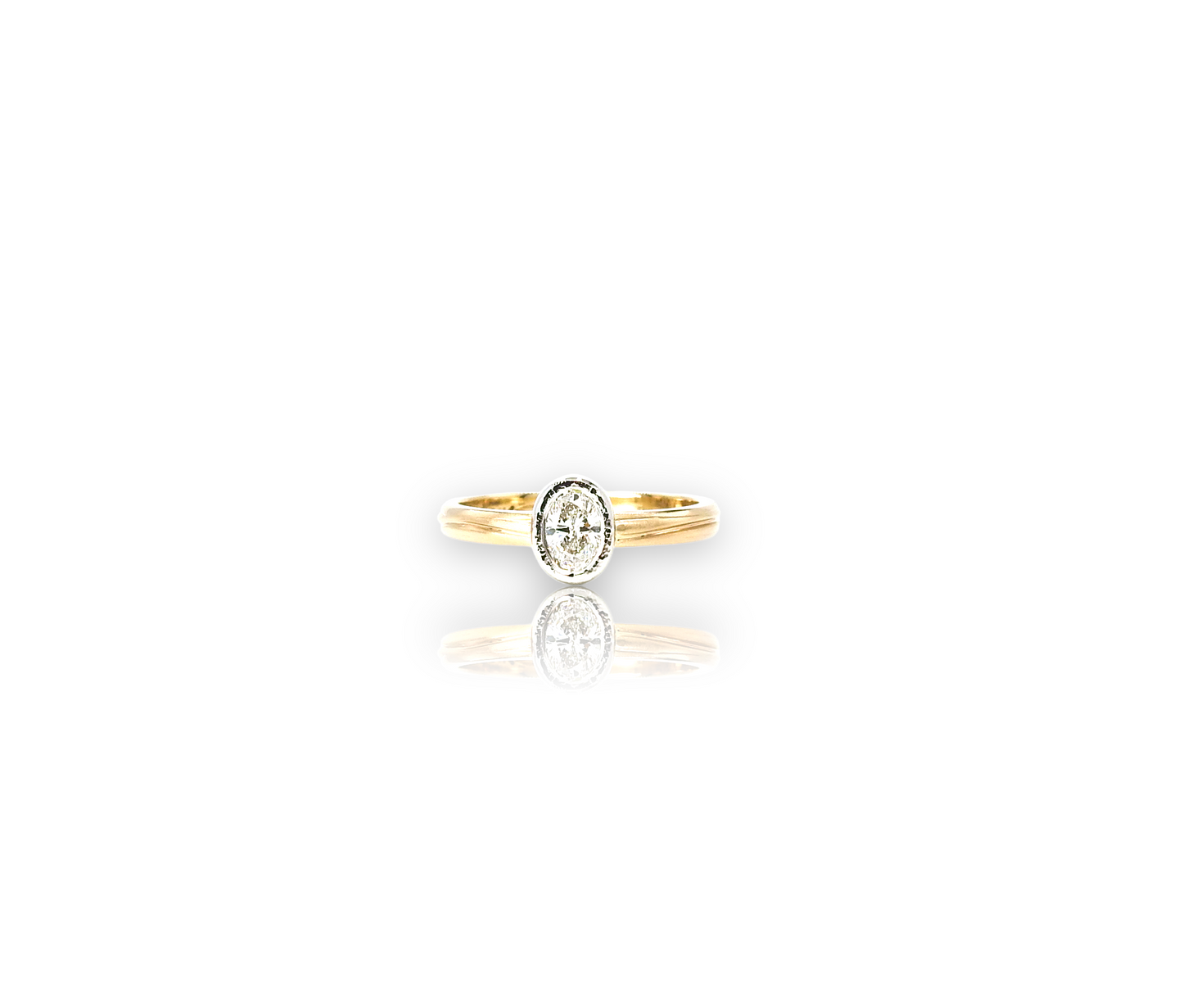 Commissioned engagement ring, oval planish bezel in two tone 14kt yellow gold band, and 18kt white gold planish bezel, with .25ct oval facetted diamond.
