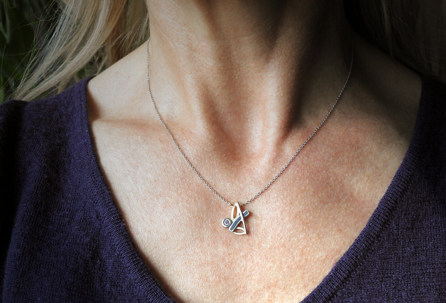 Bespoke 14kt white and yellow gold necklace with limestone inlay and .10 CT CANADAMARK - Hearts & Arrows diamond F+ VS, small 14kt yellow gold heart and arrow tag near clasp.