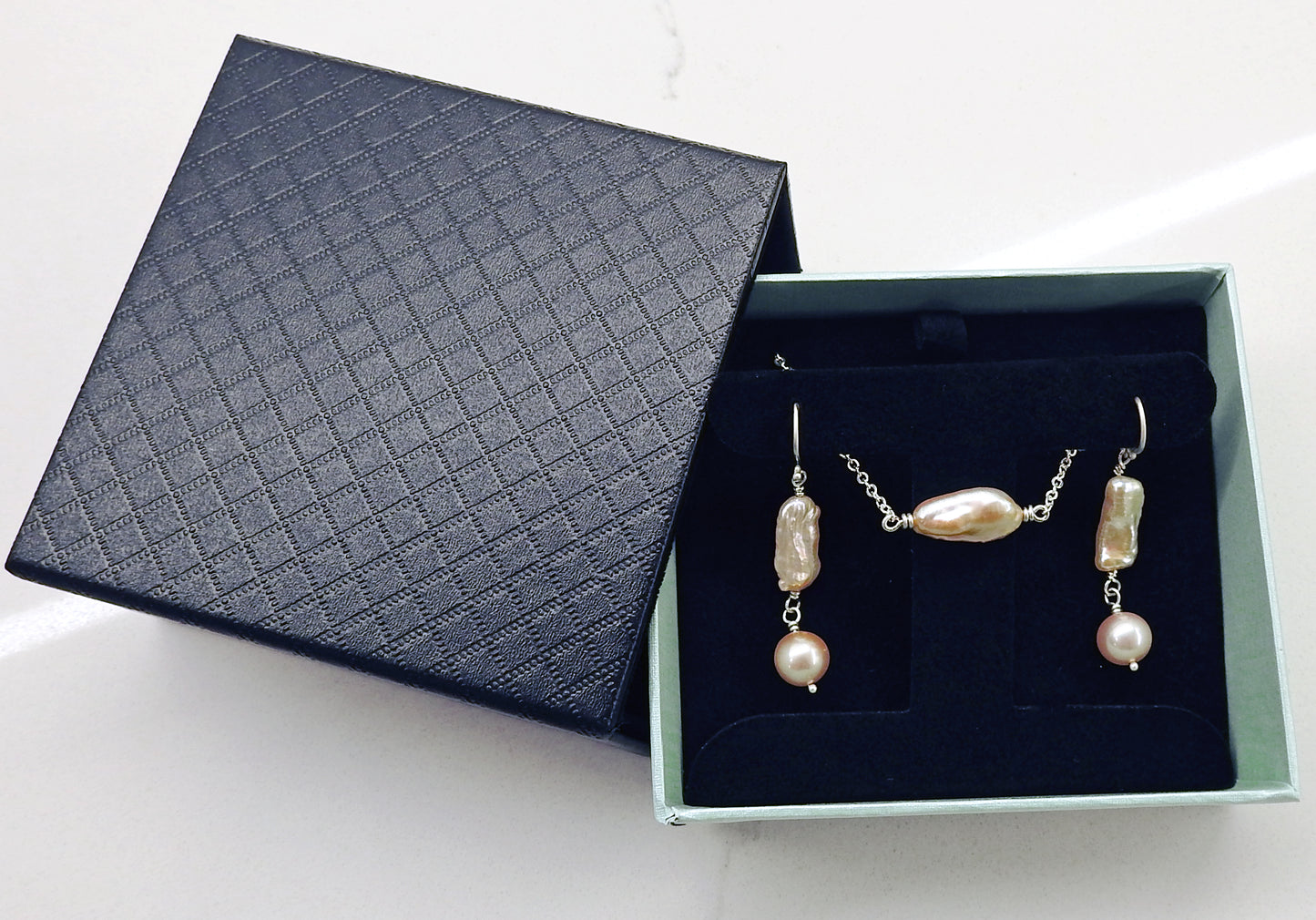 Elongated baroque cultured pearls tied with sterling silver wire, with 8.5mm round natural soft pink pearl drops, on sterling silver Shepard hooks. By ZEALmetal, Nicole Horlor, Kingston, ON, Canada