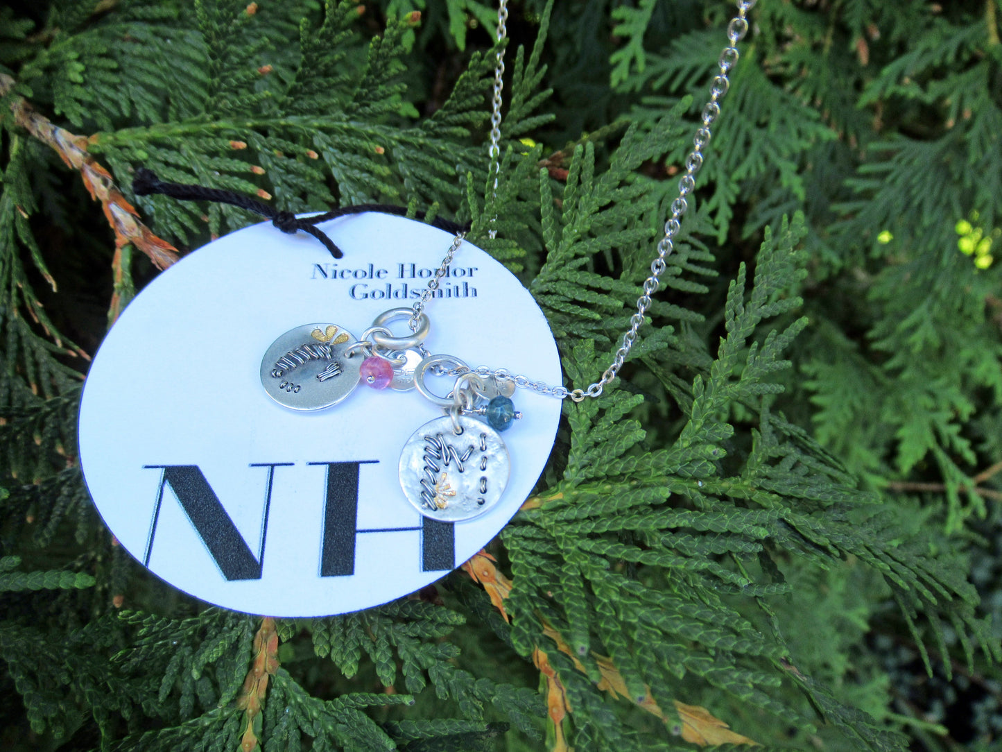 Stackable Initial pendants ~ Needle point in fine silver and sterling silver with a hint of 23kt gold, faceted pink tourmaline and NH tag. Canadian handmade in Kingston ON