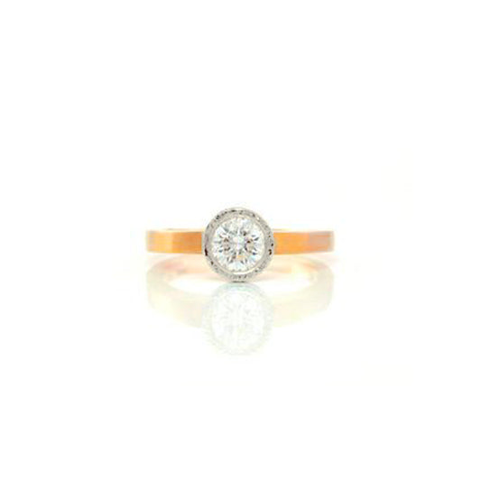 Planished bezel, classic, simple In two tone thin 18kt yellow gold band with 18kt white gold planished bezel.  This lovely ring has a beautiful .64pt Canadian diamond, by ZEALmetal, Nicole Horlor, in Kingston, ON Canada