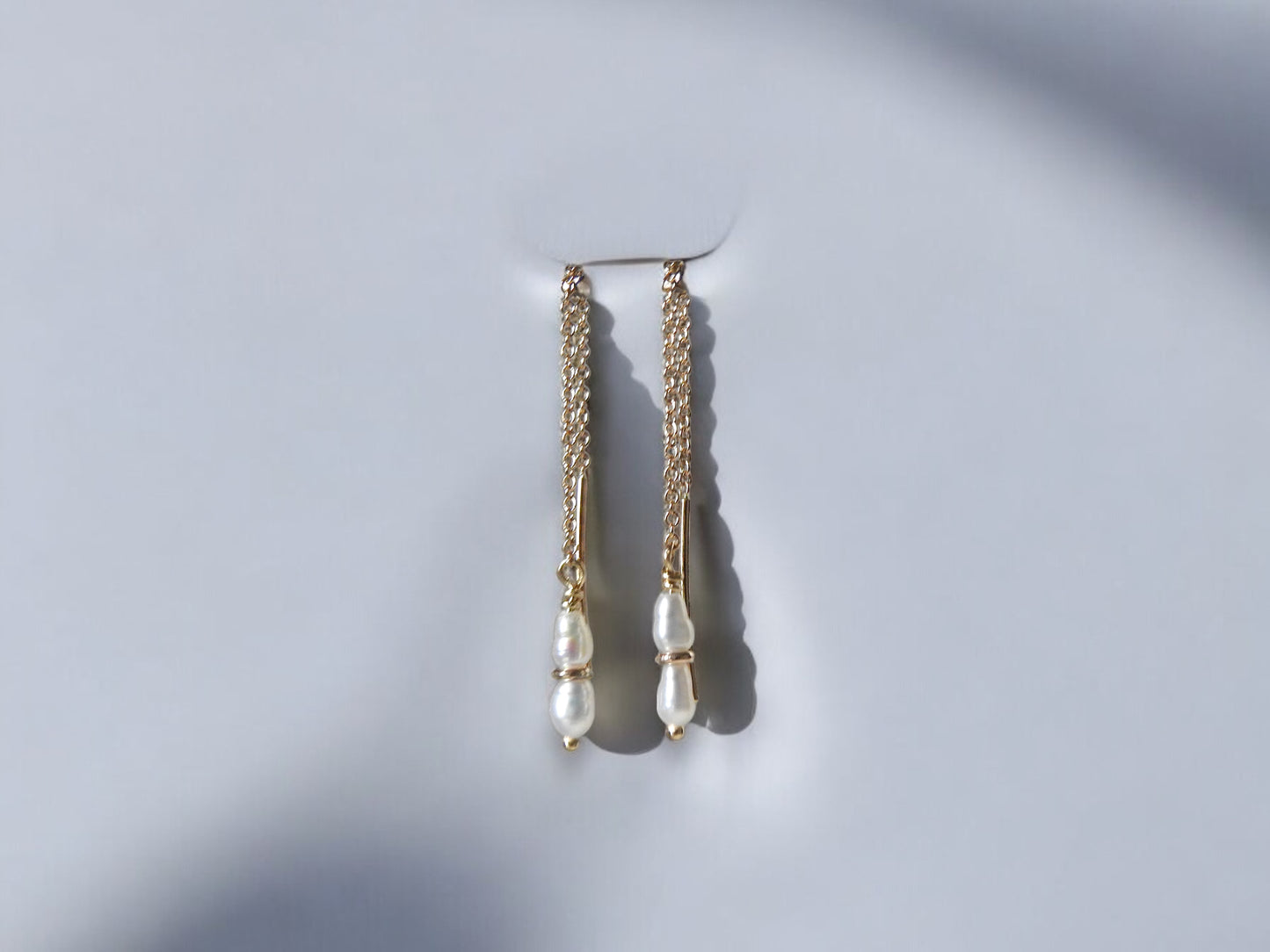 Threaded rice pearl earrings