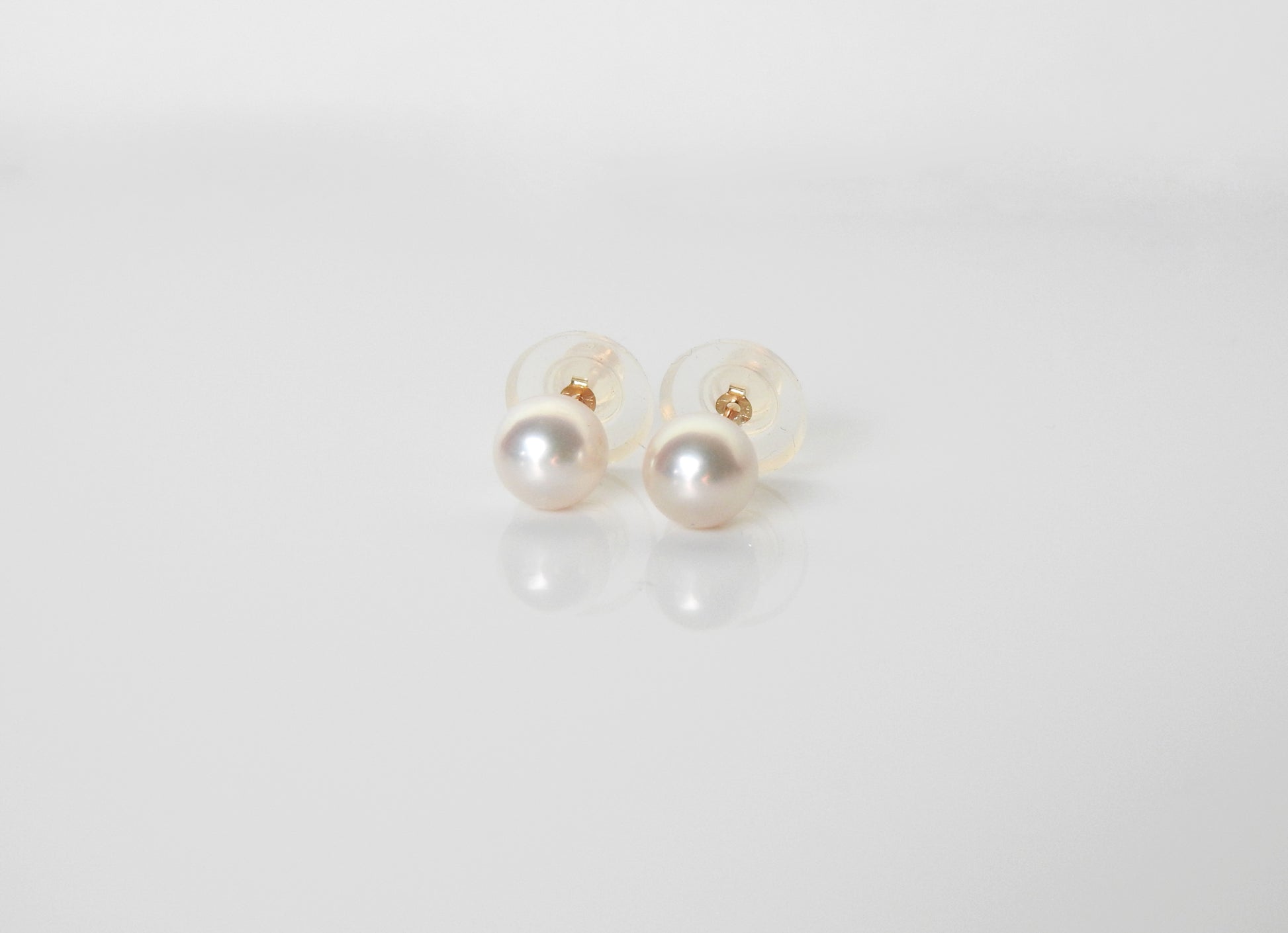 Simple classic and stunning akoya pearl studs with 14kt yellow gold cup post and 8.7mm disc silicone grip friction backs, by ZEALmetal, Nicole Horlor, in Kingston, ON Canada