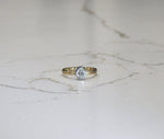 Commissioned engagement ring, oval planish bezel in two tone 14kt yellow gold band, and 18kt white gold planish bezel, with .25ct oval facetted diamond.