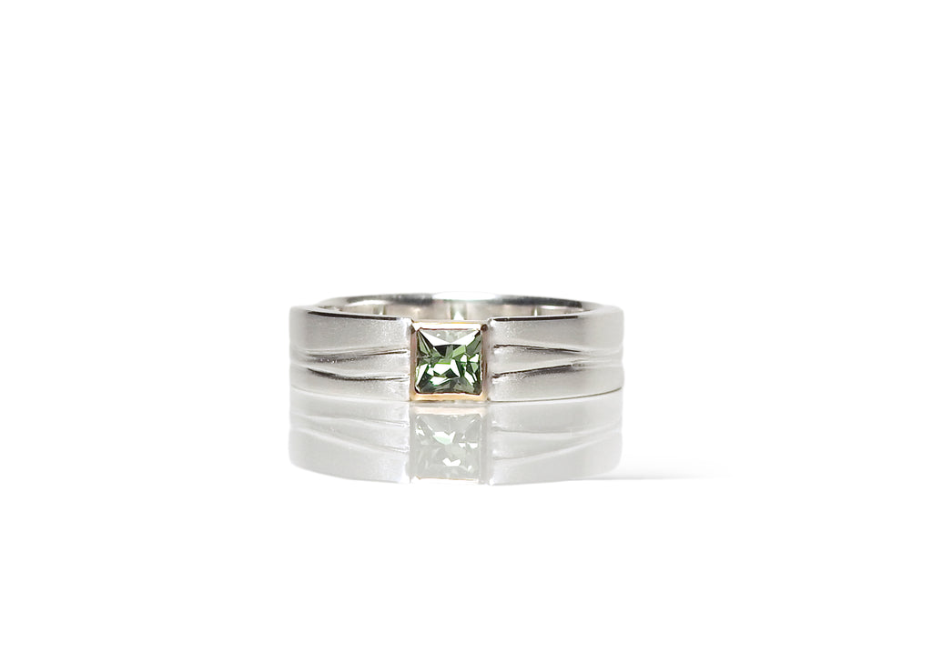 Clean classic floating bezel, green princess cut sapphire in 18kt yellow gold bezel with square edge band and carved wave detailing, by ZEALmetal, Nicole Horlor, in Kingston, ON Canada