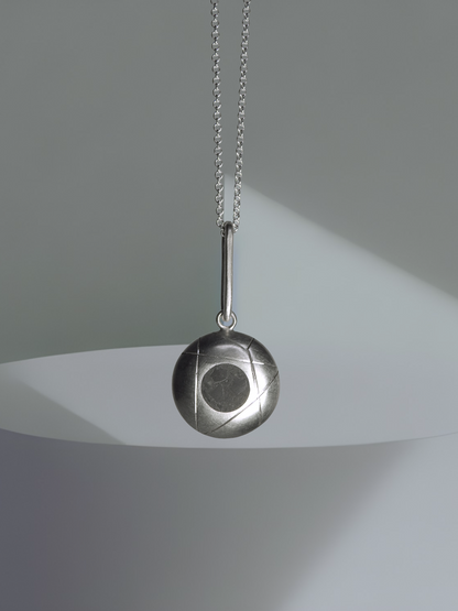Pendulum style pendant, half dome with limestone inlay, with accent carved lines hanging on elongated bale, matte and high-polish accent finishes, on 18" rounded box link chain, by ZEALmetal, Nicole Horlor, in Kingston, ON, Canada