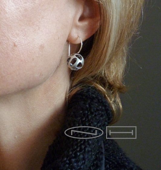 Canadian, Local, Handmade in Kingston ON by ZEALmetal Handmade with care, sterling silver spheres with soft organic pierced out holes, inside is oxidized black the outside is a matte finish.  Hoops have a saftey hook at the back for easy wear.   13mm pierced domes