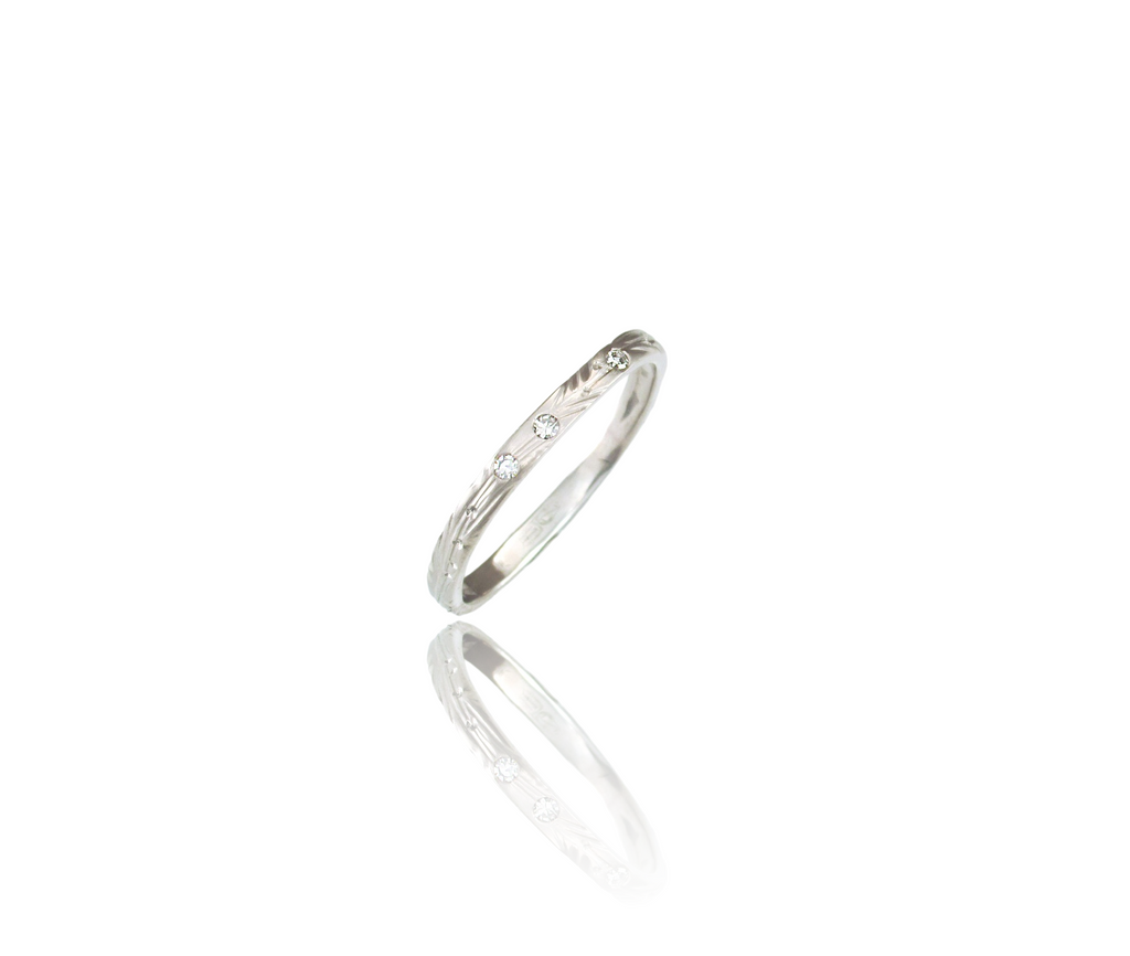 2.5mm band with hand carved vine pattern and hand stamped leafs scattered around band, with 3 x 1pter accent round brilliant cut diamonds for a little sparkle. Ring shown in image is a soft square shape but this ring can also be round, by ZEALmetal, Nicole Horlor, in Kingston, ON, Canada