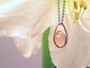 Little wire sculpture pendant with gold drop shape link,  sterling silver centre round link gently holding an un-drilled 8.5 mm rose quartz stone, free floating emphasizing space and freedom., by ZEALmetal, Nicole Horlor, in Kingston, ON, Canada